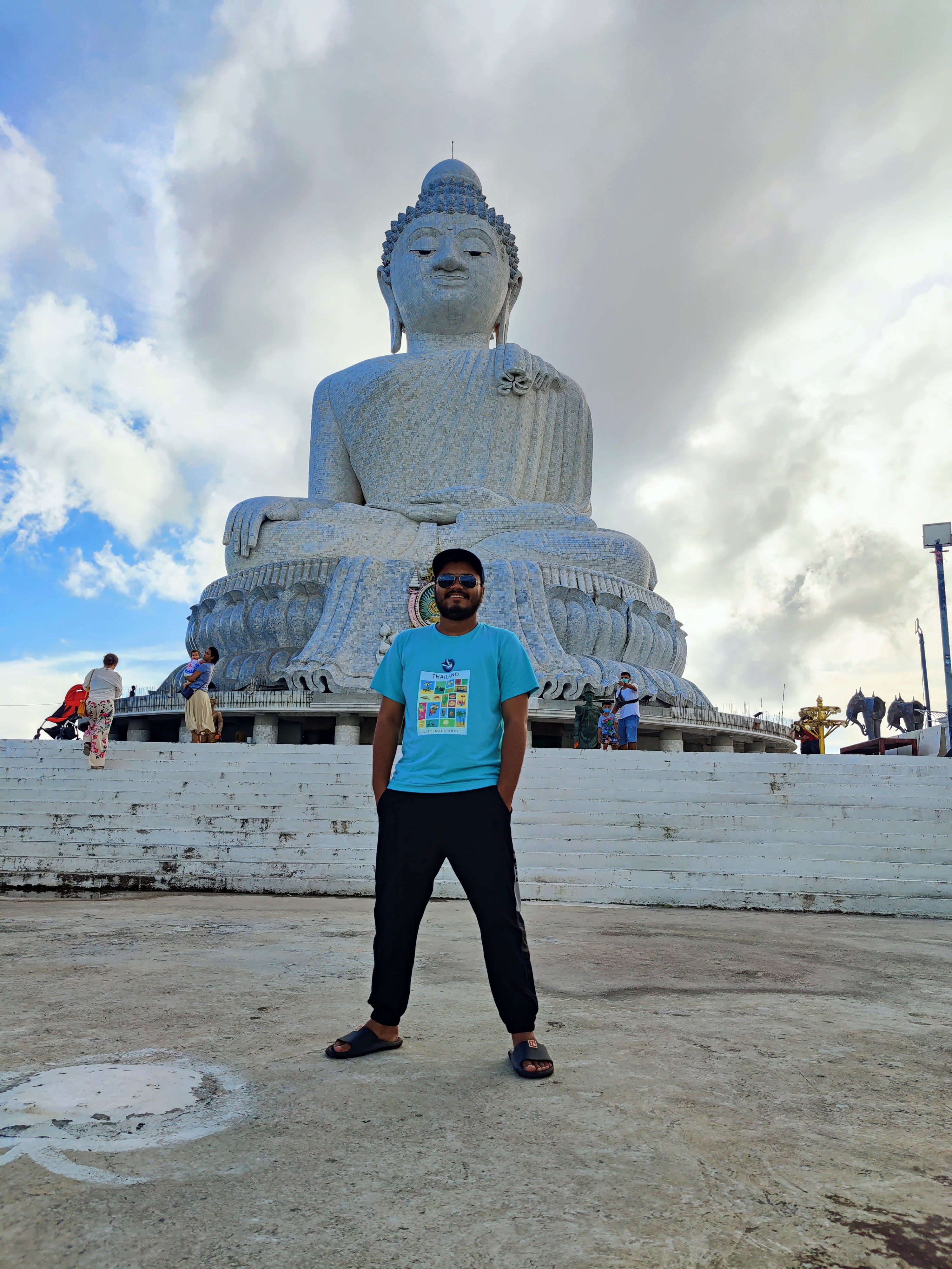 Jeanine White smiling in a red plaid shirt and tortoise shell glasses